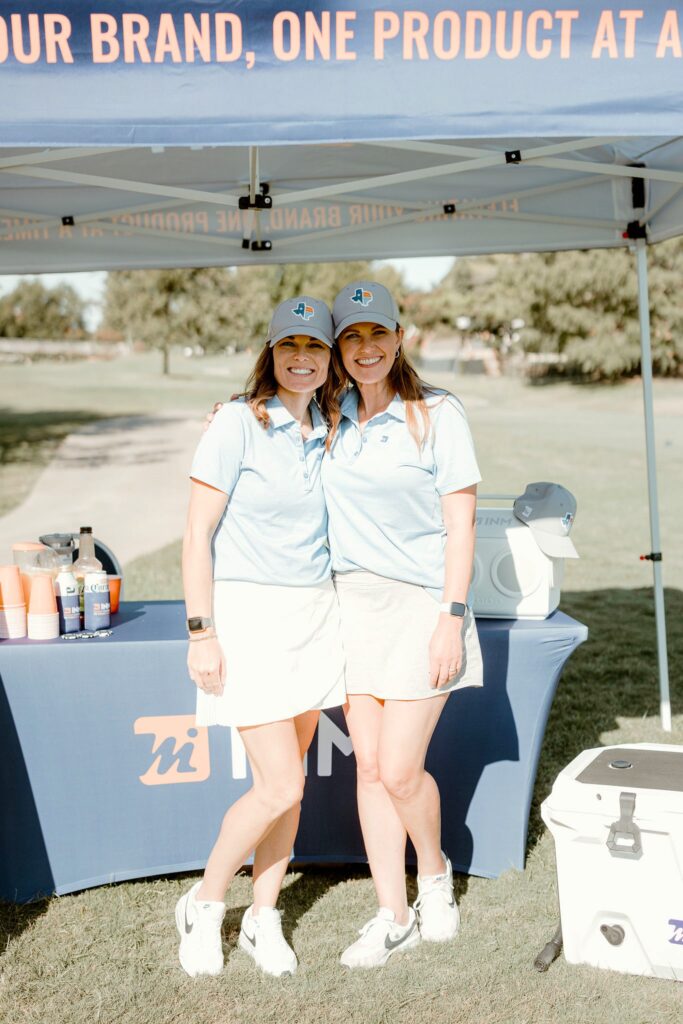 Woman at golf tournament in Travis Mathew polos.